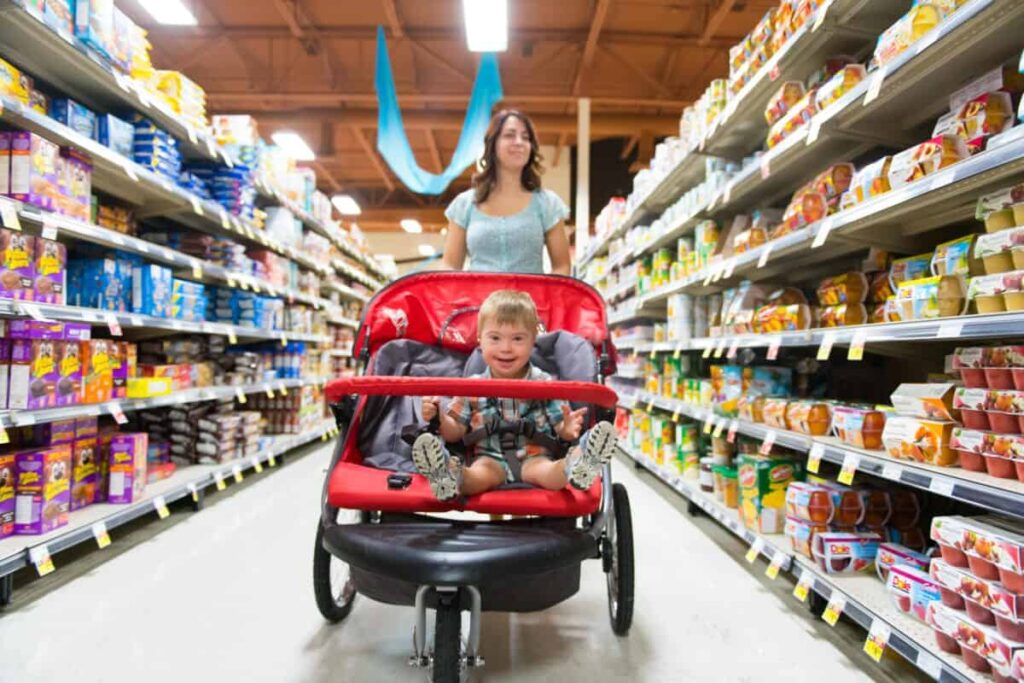 Is This TSX Dividend Yield Too Good to Be True? I Checked the Numbers A woman shops in a grocery store while pushing a stroller with a child